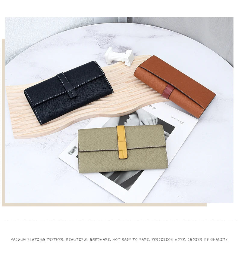A display of genuine cow leather bifold wallets in black, brown, and beige tones on a light wooden surface.