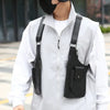 A person wearing a white jacket is shown with a black tactical chest bag worn across their body.