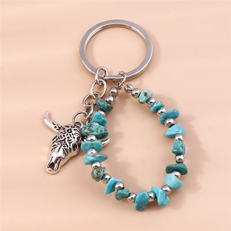 Silver keychain featuring a heart-shaped pendant made of turquoise stones.