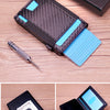 A black pop up card wallet with a money clip and a blue card insert shown in various angles.