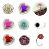 A collection of heart-shaped metal fold-over bag hooks in various colors including silver, purple, pink, and red rose gold to