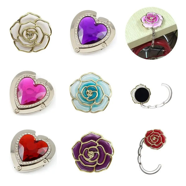A collection of heart-shaped metal fold-over bag hooks in various colors including silver, purple, pink, and red rose gold to