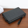A black leather portfolio or folder with a textured pattern is placed on a wooden surface.