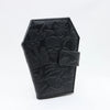 Black leather wallet featuring a vintage embossed design of a skull and foliage.