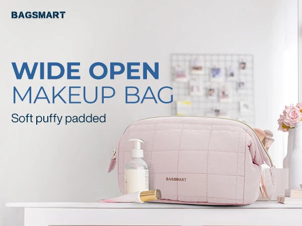 A pink padded makeup bag with a wide open design sitting on a white surface.