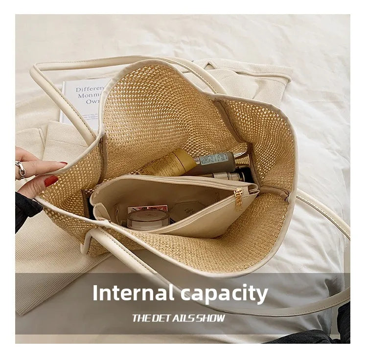 A straw woven tote bag with PU trim and a matching inner pouch is shown resting on a light-colored fabric.