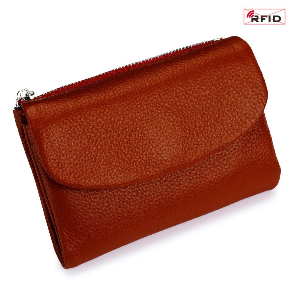 A brown genuine leather mini card holder wallet with a zipper closure.