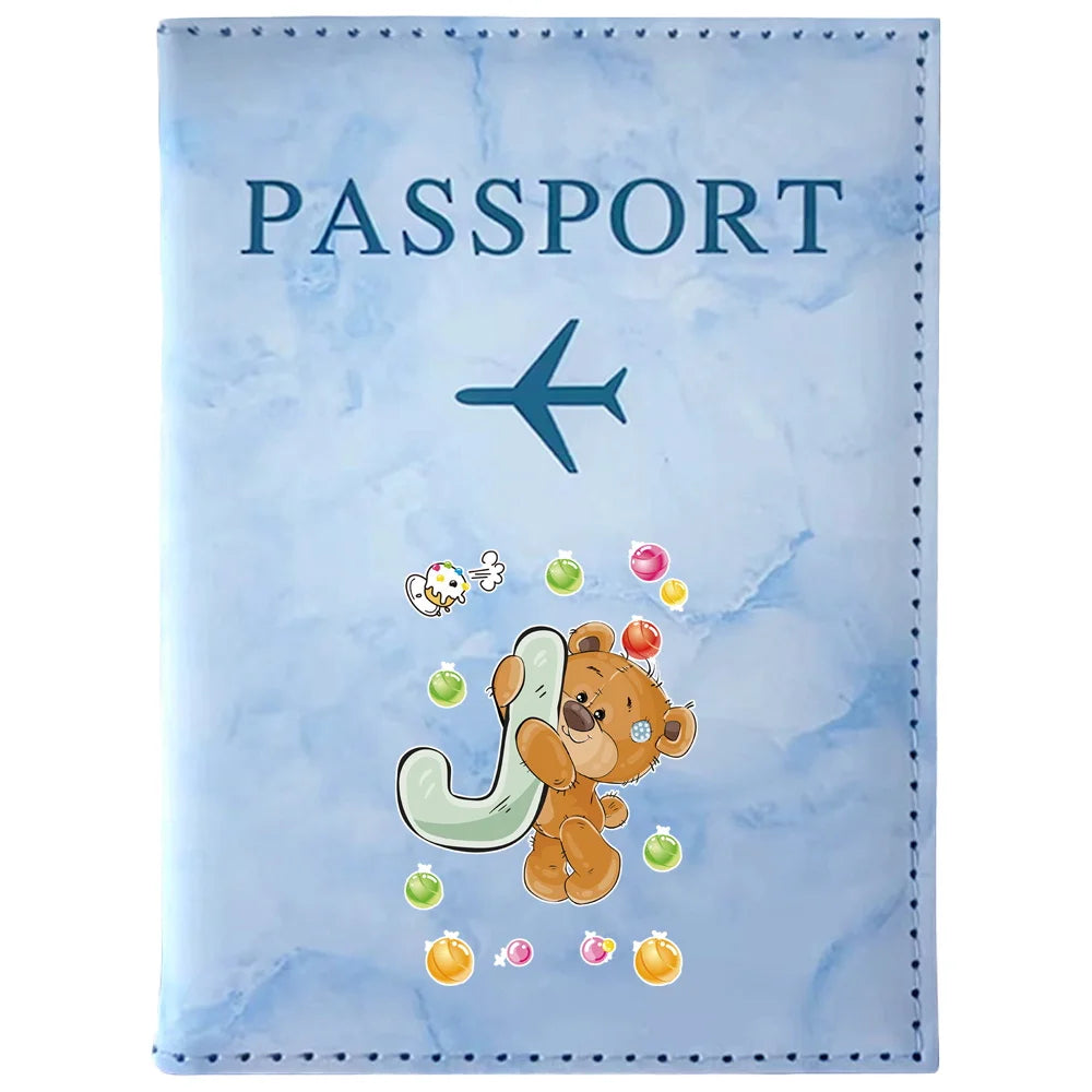 Light blue passport card holder featuring a vintage letter print design with a teddy bear and various colorful candies.