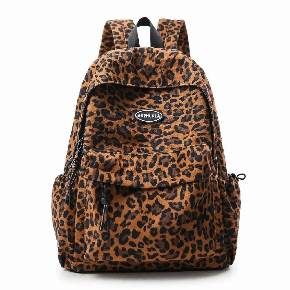 A leopard print laptop backpack featuring padded straps and a flap closure.