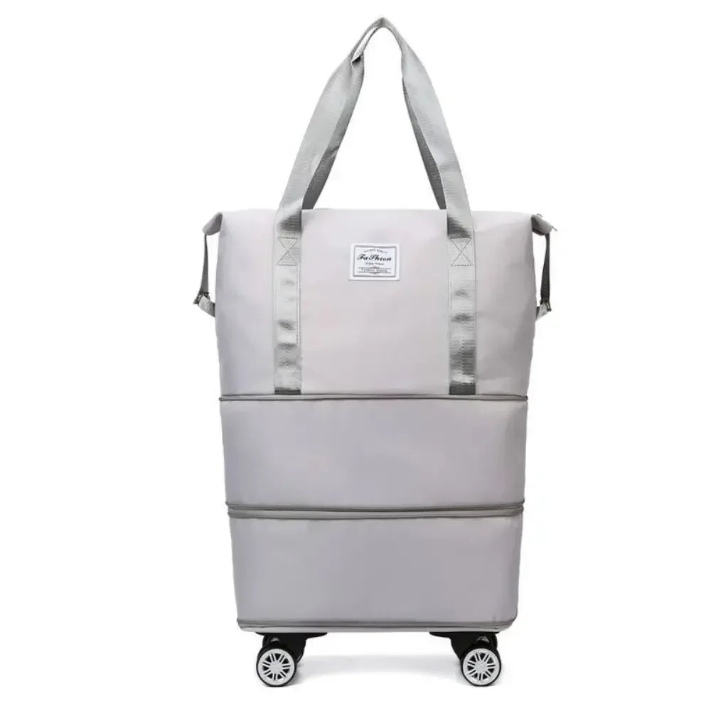 Pochette de voyage polyvalente gris clair, extensible, avec poignées en tissu et roues.