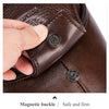 Close-up of a brown leather strap with a magnetic buckle on a men's crossbody messenger bag