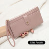 A mauve pink PU leather coin purse and card holder is shown being held by a hand on a white textured fabric.