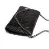 Black velvet flap crossbody bag with a silver chain strap