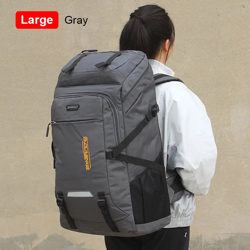 A large gray travel backpack is shown being carried by a person against a light background.