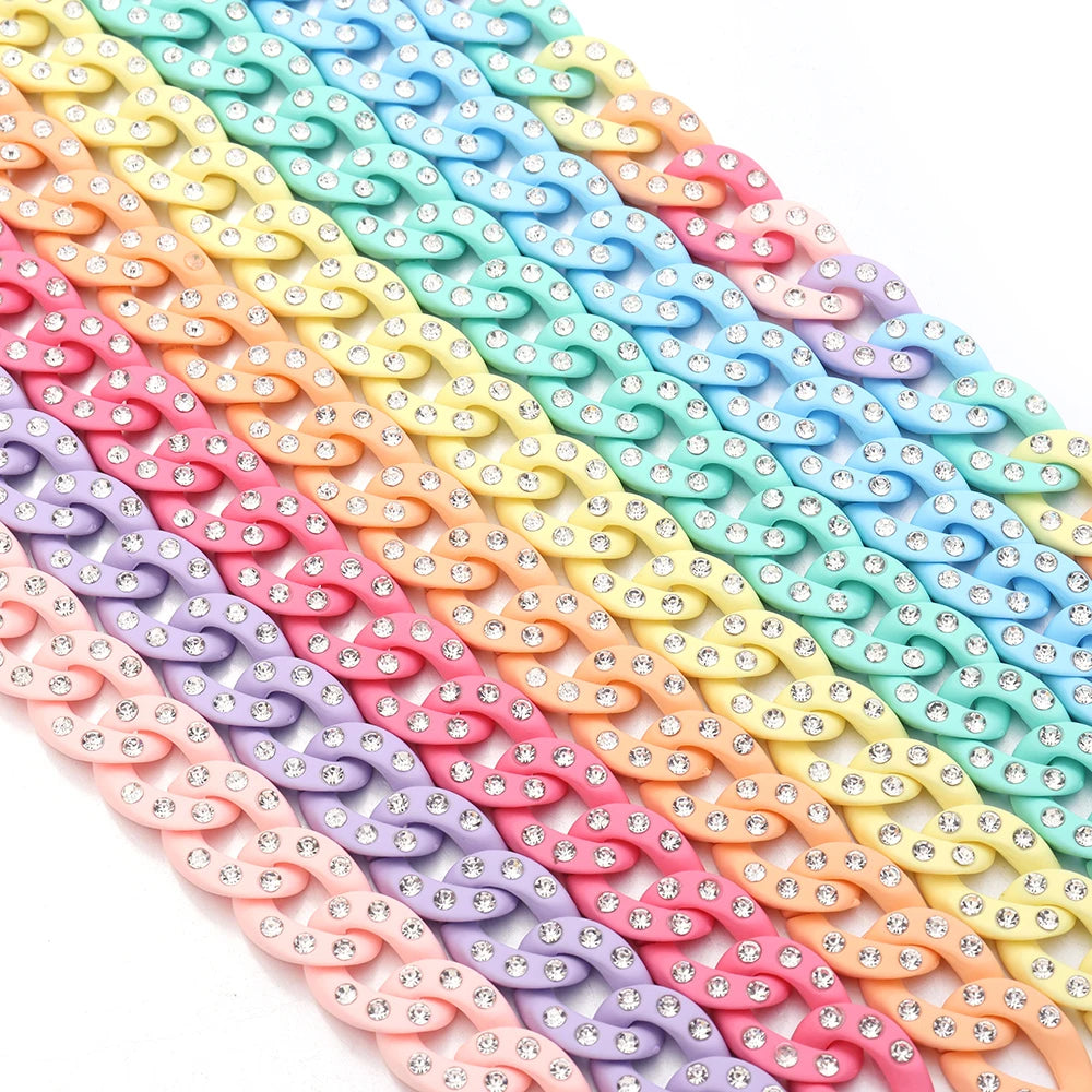 A close-up of multiple strands of colorful acrylic link chains in a rainbow gradient.