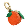 Runde orange Frucht-Anhänger an einem goldfarbenen Schlüsselanhänger.