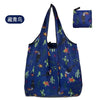 A dark blue reusable eco tote shopping bag featuring a pattern of colorful leaves and plants.