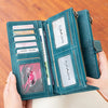 A teal leather trifold clutch wallet is shown in various views, including a closed form and an open display of cards.