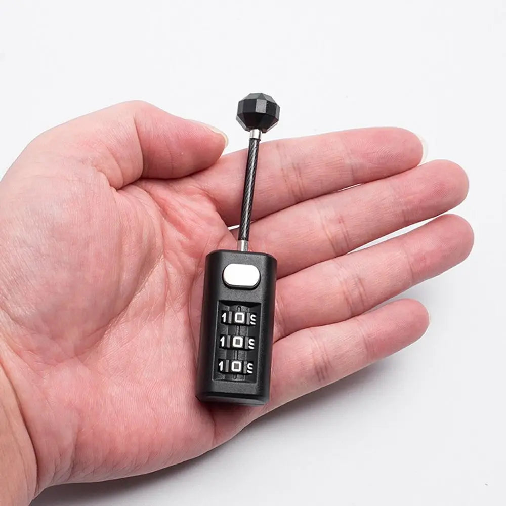 A hand holds a black resettable 3-digit combination padlock with a metal shackle.