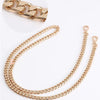 Gold-toned adjustable metal chain strap for a handbag.