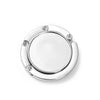 A silver folding alloy handbag hanger hook with a circular design.