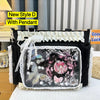 A black shoulder tote bag with a clear front panel featuring a pink-haired character design and white lace trim.