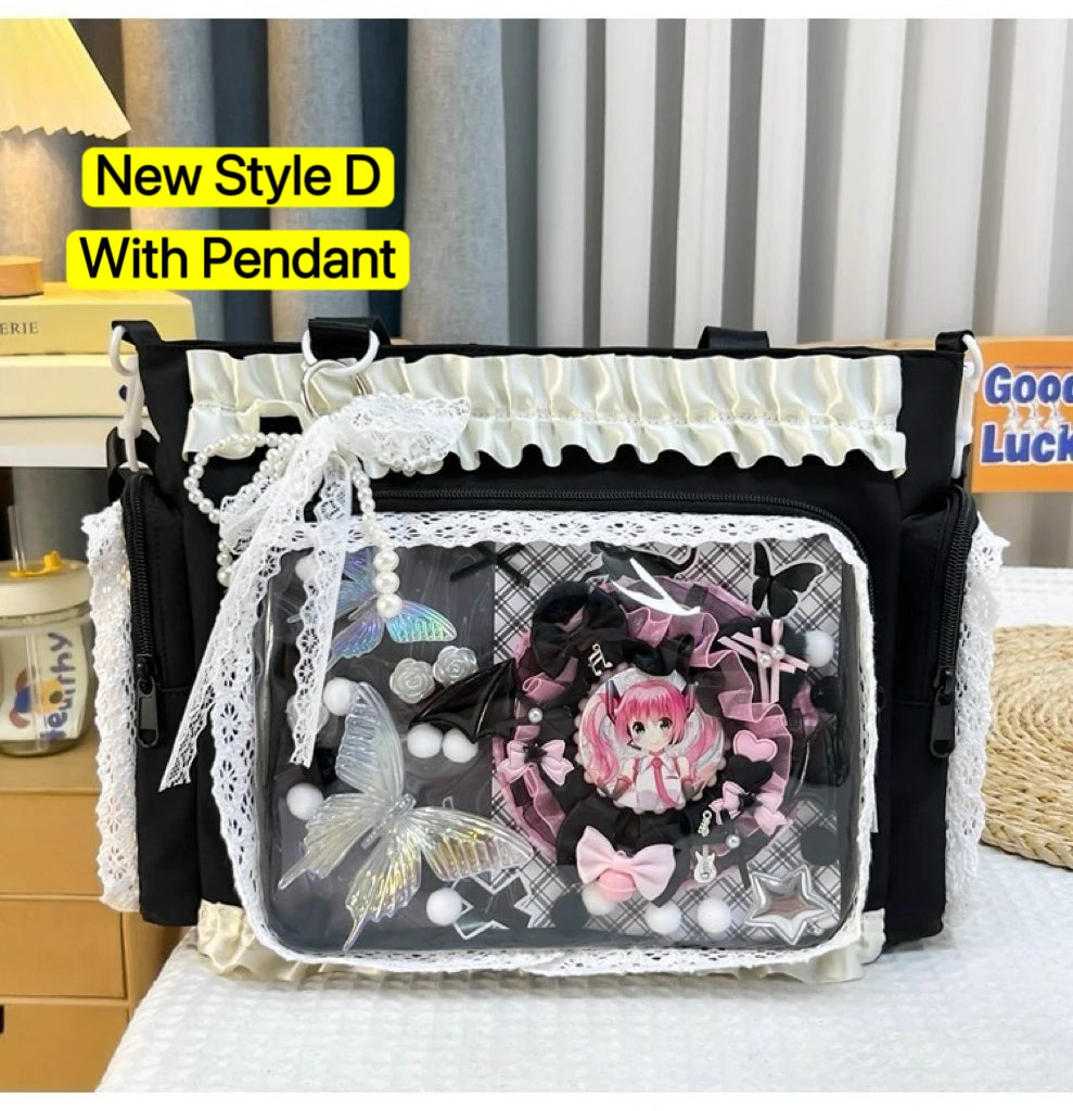 A black shoulder tote bag with a clear front panel featuring a pink-haired character design and white lace trim.