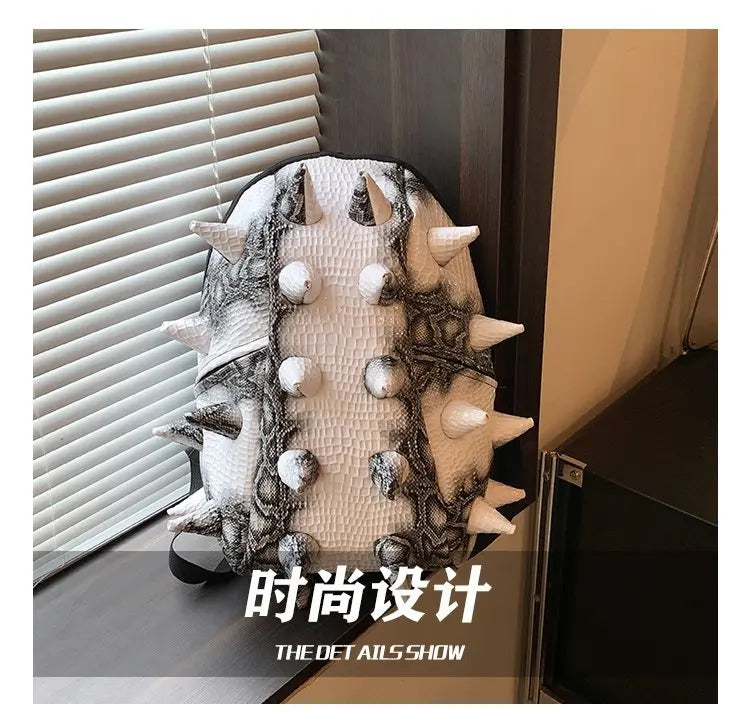 A white and black hedgehog-shaped PU backpack displayed on a dark surface.