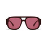 A pair of oversized square sunglasses with a dark maroon frame and pinkish-red lenses.