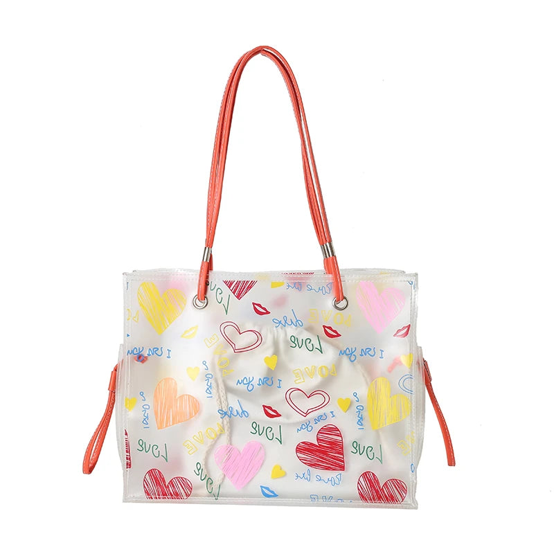 A clear plastic shoulder bag set with pink straps and heart-shaped confetti print.