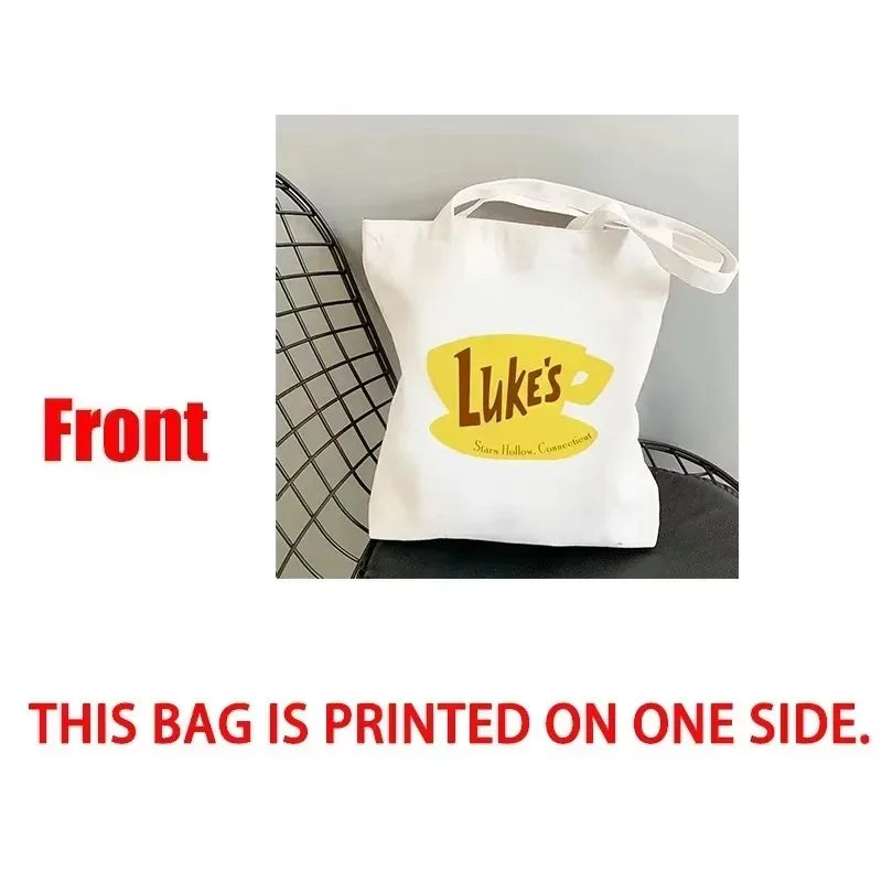Sac de course blanc avec un logo jaune affichant le texte Luke's et des étoiles.