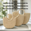 Three handwoven rattan beach bags of varying sizes and styles displayed on a white surface.