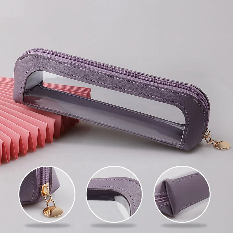 A purple cosmetic organizer pouch with a clear window and gold chain attached, shown from the side.