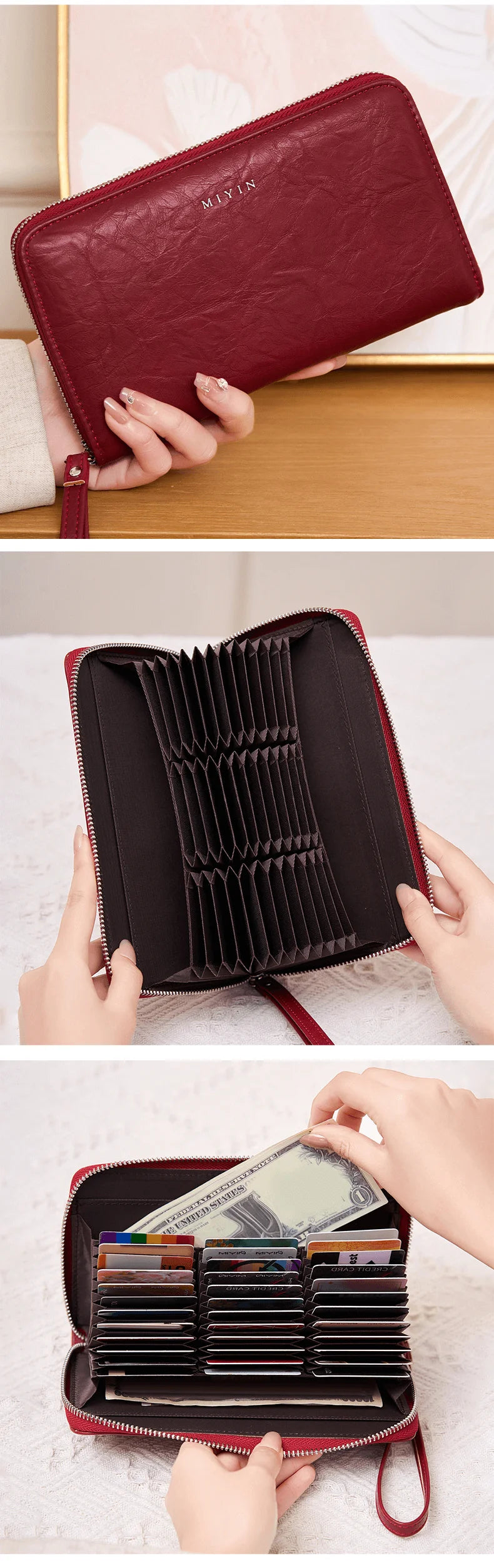A close-up of a maroon leather wallet with a zipper closure being held by a hand.