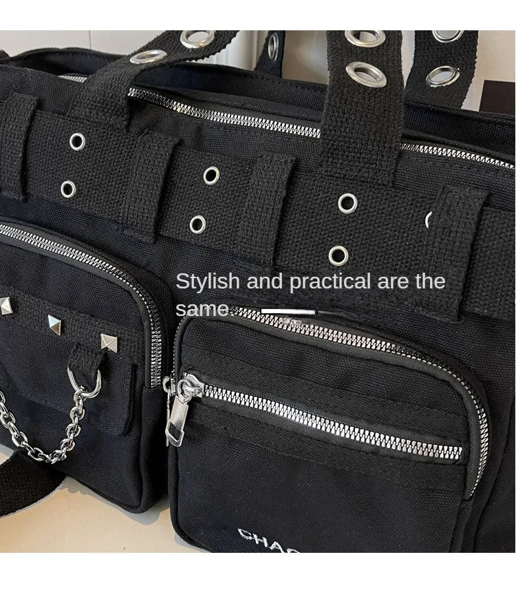 Black nylon shoulder bag featuring multiple zippered pockets and rivet details