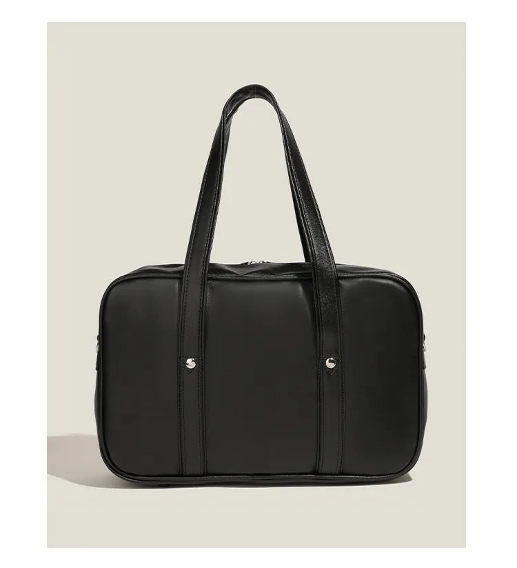 Black waterproof PU leather shoulder bag with a top handle shown against a light background.