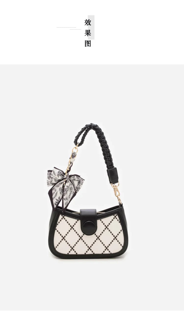 A black and white quilted bow bag with a black leather strap and gold chain extension.