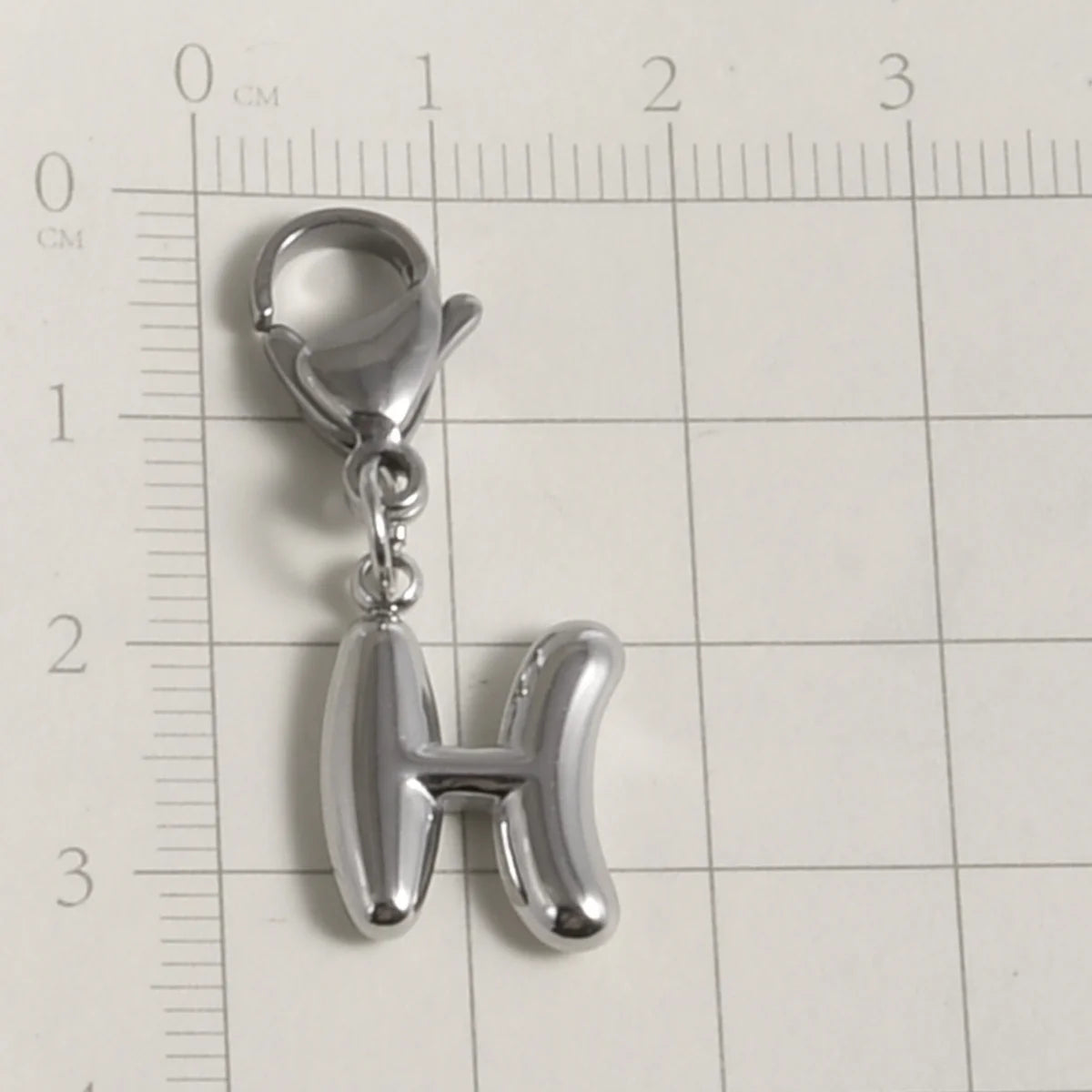 Silver stainless steel alphabet letter charm shaped like the letter H with a lobster clasp