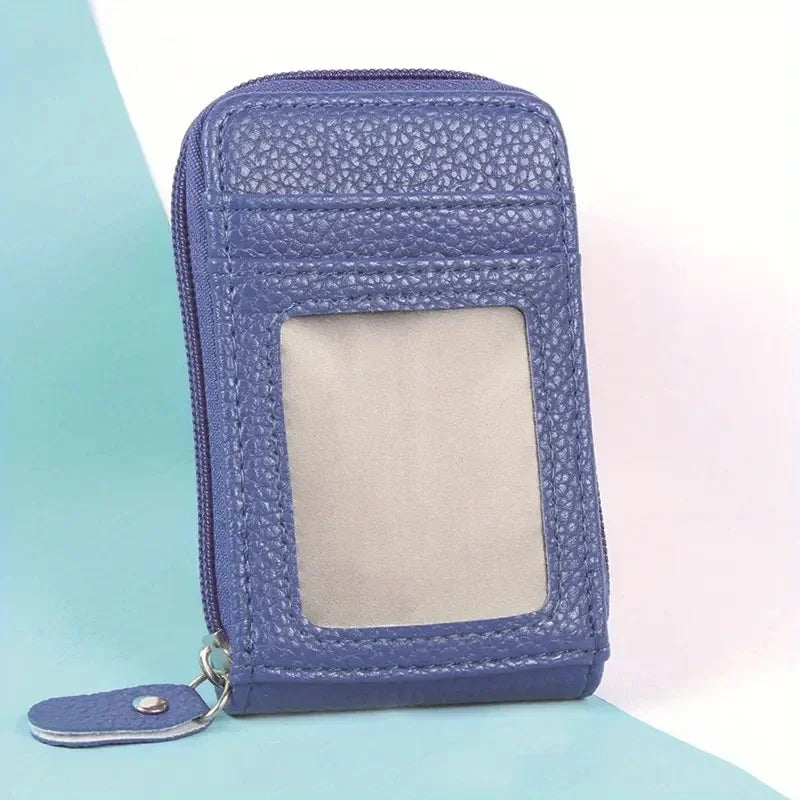A purple leather card holder wallet with a clear window and a silver clasp.