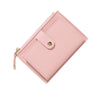 A pink leather wallet with a flap closure and a zipper pull is shown at an angle.