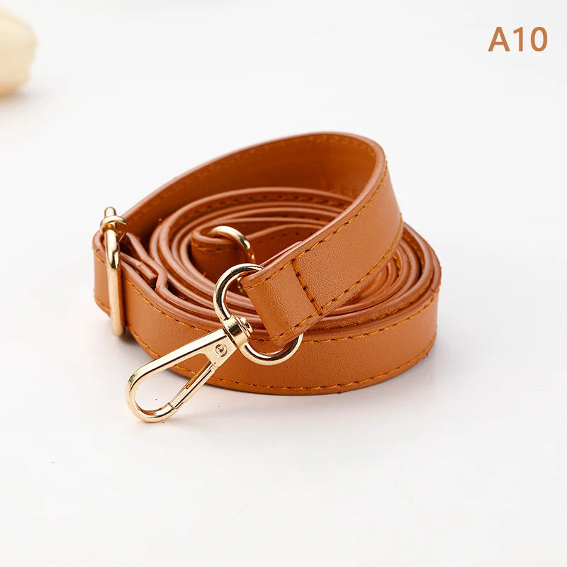 A brown PU leather strap coiled and featuring a gold-toned buckle for an adjustable crossbody bag.