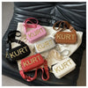A collection of various colored leather tote bags displayed on a dark surface.