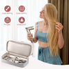 A woman is using a handheld hair dryer on her long blonde hair, with an accessory storage case nearby.