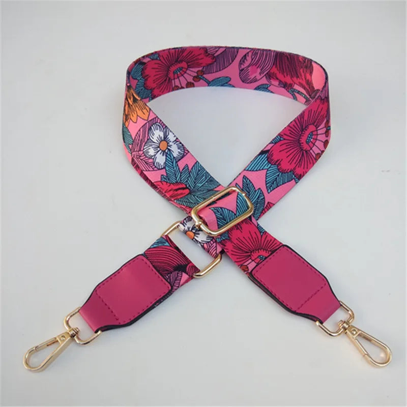 Sangle réglable à épaule rose et à motifs floraux pour sac bandoulière.
