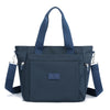 A dark navy durable nylon tote bag with shoulder straps and a secure zipper closure.