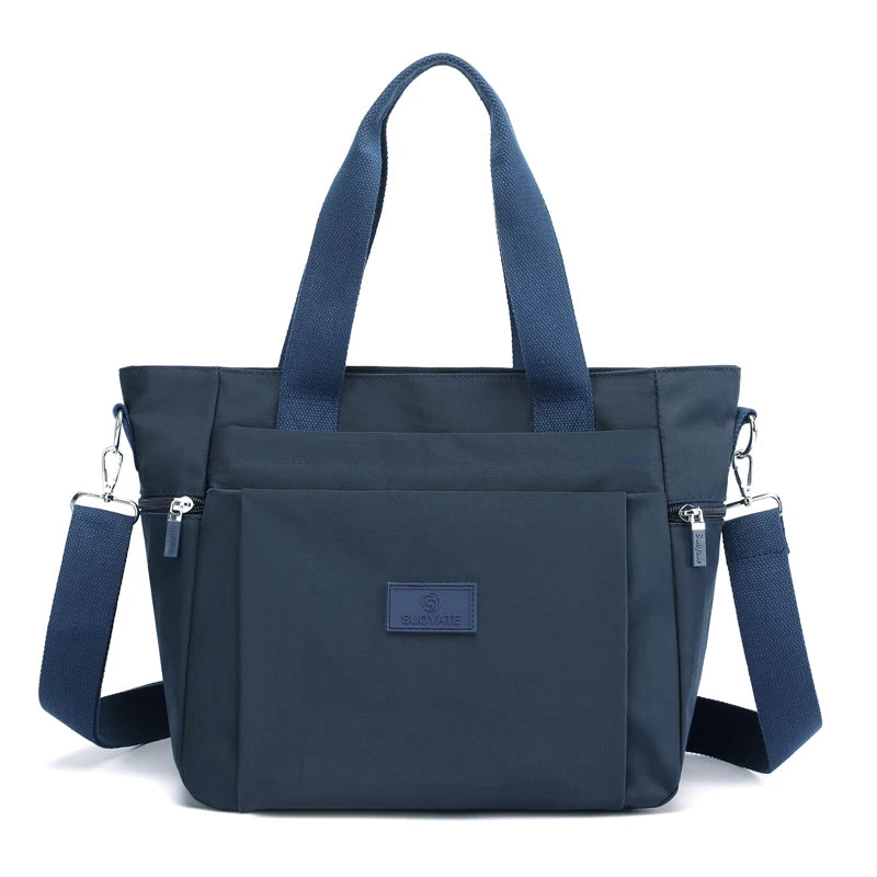 A dark navy durable nylon tote bag with shoulder straps and a secure zipper closure.