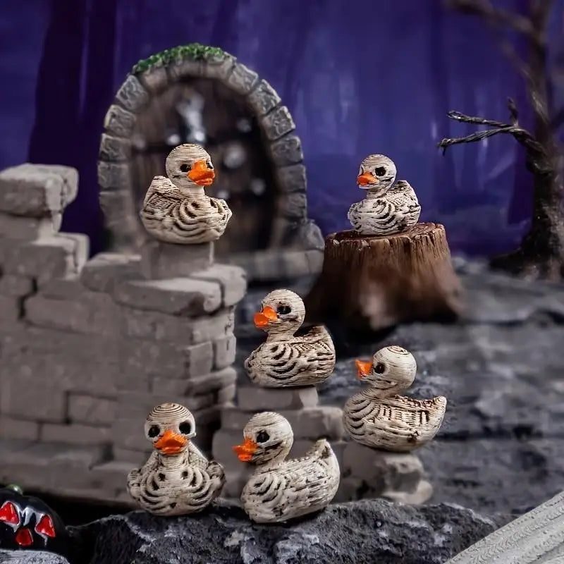 A set of small, realistic duck figurines resembling skulls and feathers displayed in a rustic outdoor setting.