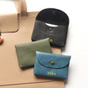 A collection of genuine leather card holders and coin purses in shades of tan, olive green, and black.