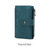 A dark teal leather clutch wallet with a flap and zipper, shown against a white background.