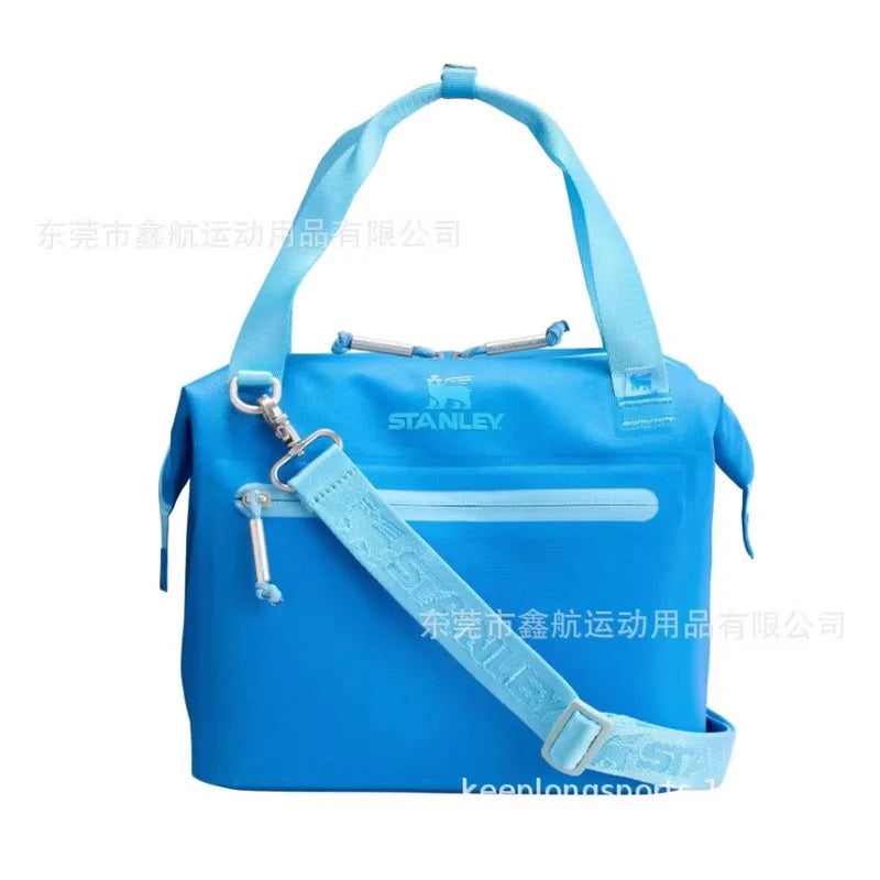 A bright blue insulated cooler lunch bag with a detachable strap is shown against a white background.